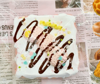 chocolate drizzle cream cake PU squishy with pink textured cream and colorful decorations