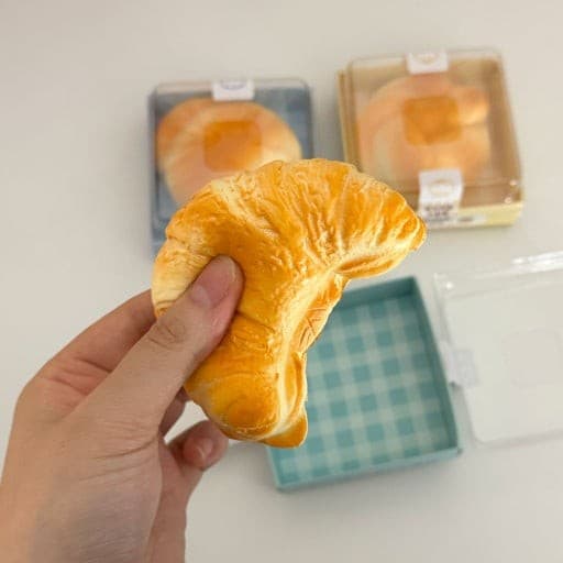 Custom Croissant Squishy — Realistic PU Bakery Toy — Hand-pressed shape demonstration