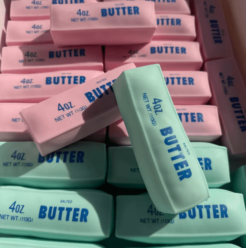 Pink and mint green TPR crunchy butter squishy bars with printed butter-stick artwork