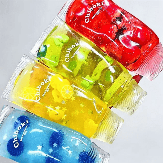 Transparent red green yellow and blue TPR tube squishy toys with glitter decorative inserts and caps
