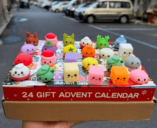 Christmas mystery dumpling squishy advent calendar with colorful festive bun characters and mixed squeeze toys displayed on a 24-gift box
